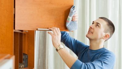 Man cleaning wooden furniture - www.freepik.com